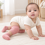 Baby model Sara wearing rose pink knee pads and matching grip socks