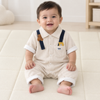 Baby boy wearing cream collared bear romper